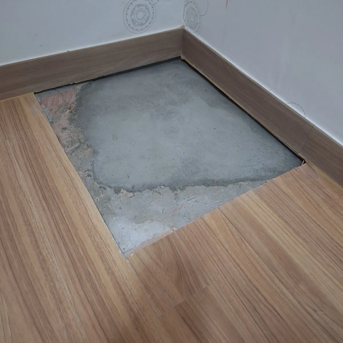방 벽면 모서리 바닥 수도배관 누수공사 후 강마루 부분 보수 이전